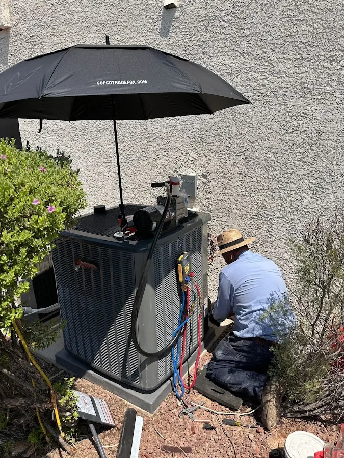 HVAC technician performing outdoor AC maintenance in Bloomfield